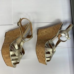 A pair of Steve Madden wedge sandals for women size 8 U.S. color Gold